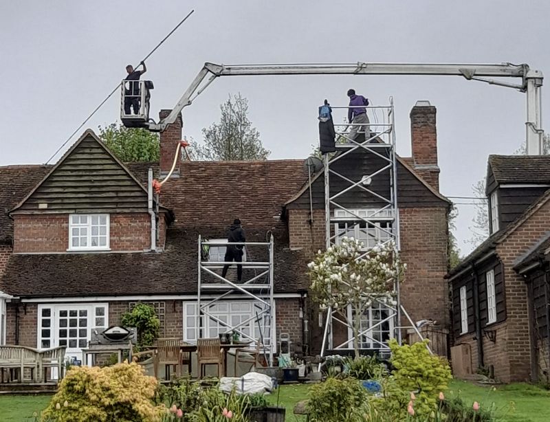 The Roof Moss Cleaners using cherry picker and scaffolding to clean roof safely and professionally in Earley, Berkshire